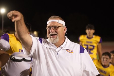 Head Coach Rich Tuman applauds his Tigers Friday night after the big win over Hanford. 